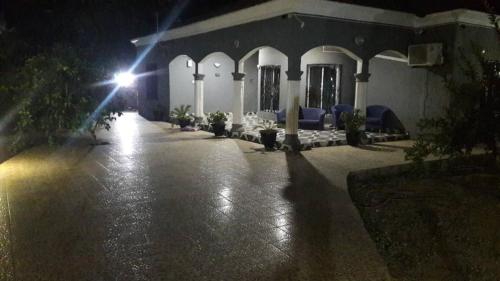 a building with a lit up courtyard at night at Remarkable 4-Bed with air conditioning in Brikama in Brikama