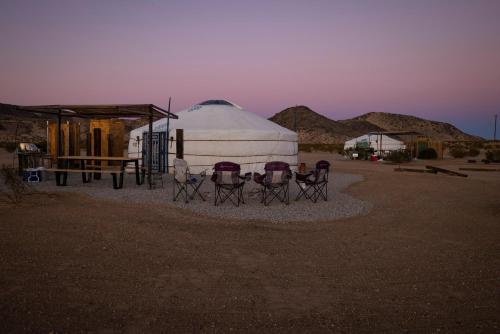 a group of chairs sitting in front of a yurt at Family Style Star gazing Yurt in Twentynine Palms