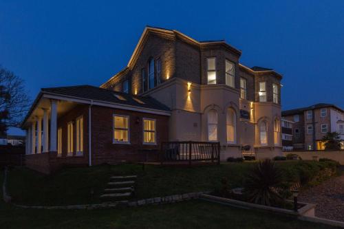 a large house at night with its lights on at Remaotel Seafield Court Apartments in Great Yarmouth