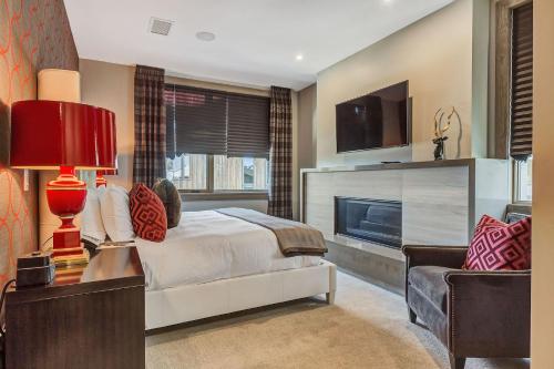 a bedroom with a bed and a fireplace at Stein Eriksen Residences in Park City