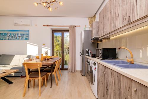 a kitchen with a table and a kitchen with a couch at Villa Foteini in Skinária
