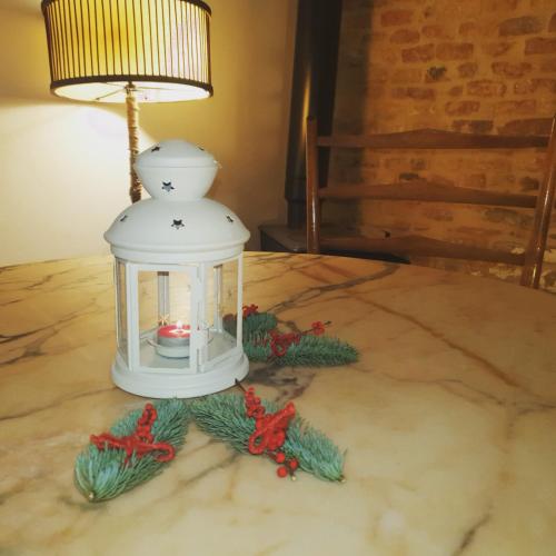 a white lantern with christmas decorations on a table at La Dimora del Cont'Orto in Giulianova