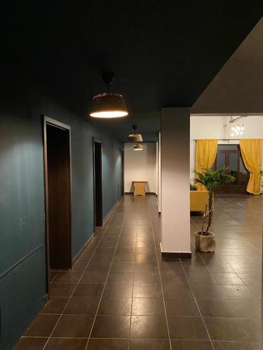 an empty room with a hallway with a potted plant at Pensiunea Bike&Bed in Moieciu de Jos