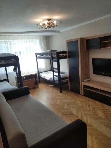 a living room with a couch and a tv at Тисовець квартира in Tysovets