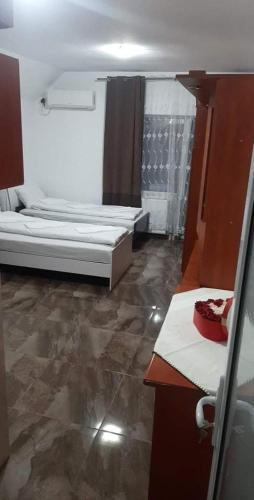 a small room with two beds and a bathroom at CASA ARDELEANULUI in Satu Mare