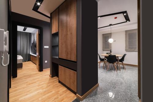 a room with black walls and a dining room with a table at Modern Mountain La Stella in Kolašin