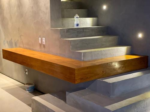 a set of concrete stairs in a room at Casa Encanto dos Milagres in São Miguel dos Milagres