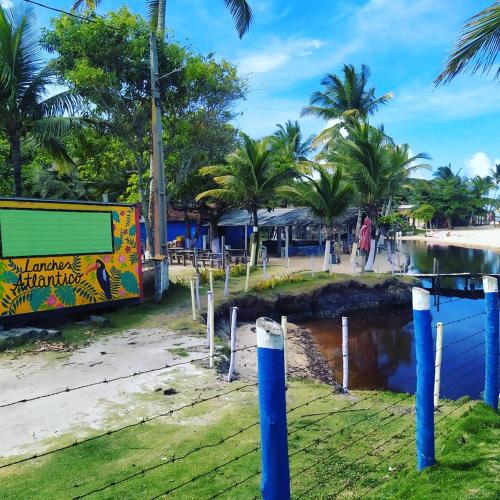 a mural on the side of a beach with palm trees at Casa com piscina - Prado in Prado