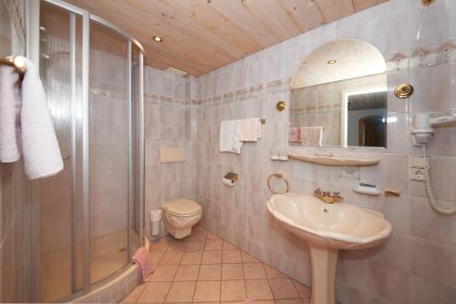 a bathroom with a sink and a shower and a toilet at Pension Pitze in Sölden