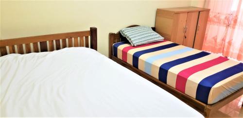 Postelja oz. postelje v sobi nastanitve Baan Yuyuen