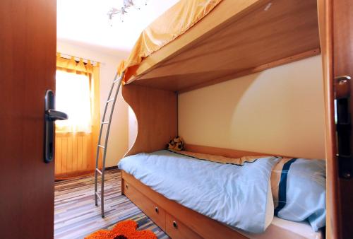 a bedroom with a bunk bed with a ladder at Apartment Kalina Hills in Ičići