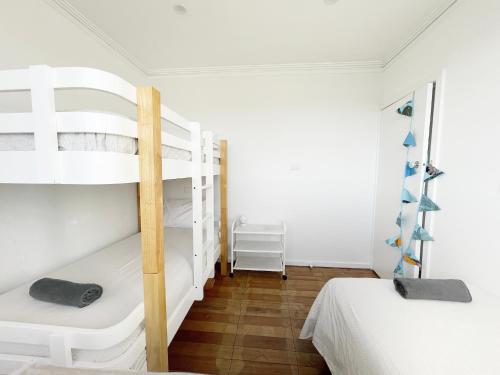 a bedroom with two bunk beds and a wooden floor at Rye Pier Apartment in Rye