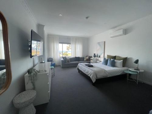 a bedroom with a bed and a living room at Rye Pier Apartment in Rye