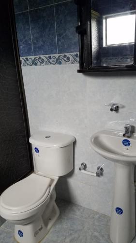 a bathroom with a toilet and a sink at Finca Hotel - Piscina La Johanna in La Mesa