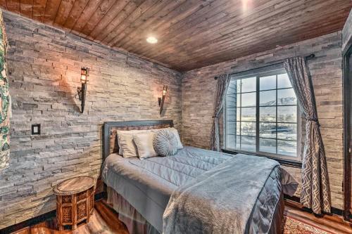 Un dormitorio con una cama y una pared de ladrillo. en Medieval-Themed Home with Large Jacuzzi and Theater!, en Taylorsville
