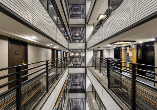 a walkway in a building with metal railing at APA Hotel Hakata Gion Ekimae in Fukuoka
