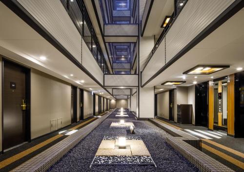 a hallway of a building with a row of lights at APA Hotel Hakata Gion Ekimae in Fukuoka