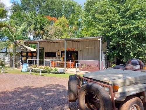 an old truck parked in front of a building at Litchfield Tourist Park in Batchelor