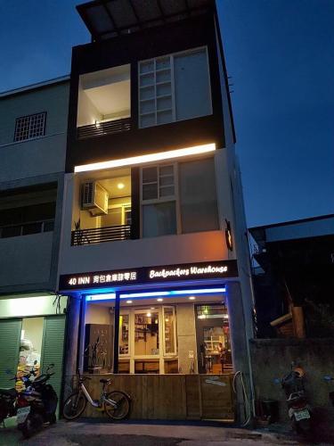 a building with a motorcycle parked in front of it at 40Inn Backpackers Warehouse in Taitung City