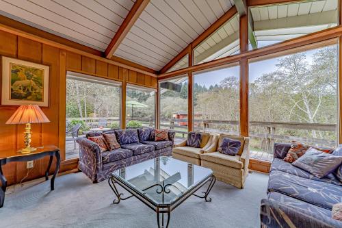 a living room with couches and a table at Mimi's Ranch House in Bayside