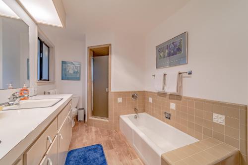a bathroom with a tub and a sink and a bath tub at Mimi's Ranch House in Bayside