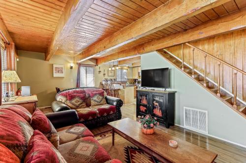 Una sala de estar con un sofá y una chimenea. en Adorable Explorable, en Lake Arrowhead