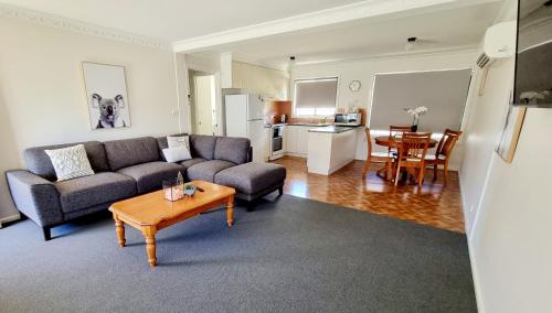 a living room with a couch and a table at The Convent Boutique Accommodation in Hay