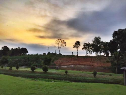 a field with trees on top of a hill at Vimannam Resort in Phetchaburi
