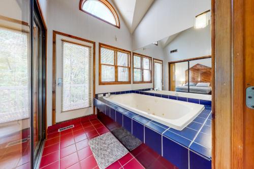 a large bathroom with a tub and red tiles at Mountainside Oasis in East Stroudsburg