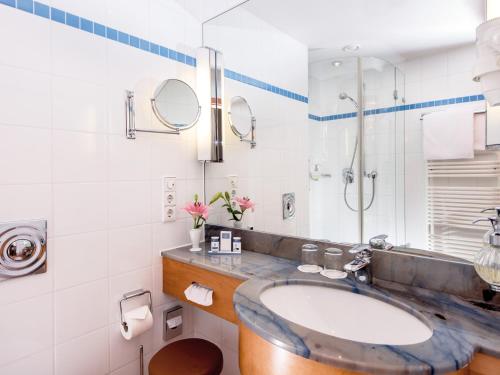 a bathroom with a sink and a shower at Hotel Bernstein Prerow in Prerow