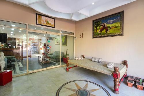 a living room with a table and a picture on the wall at Hotel Pinjore Holiday Home in Pinjaur