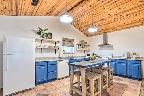 a kitchen with blue cabinets and a wooden ceiling at Relaxing Rural Harrison Home - 11 Mi to Town in Harrison