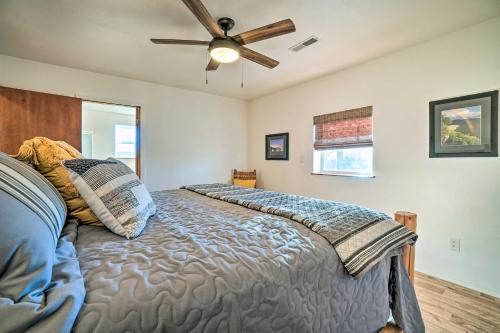 a bedroom with a bed with a ceiling fan at Relaxing Rural Harrison Home - 11 Mi to Town in Harrison