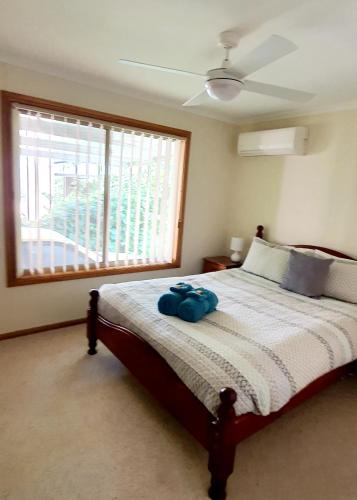 a bedroom with a bed and a large window at The Convent Boutique Accommodation in Hay
