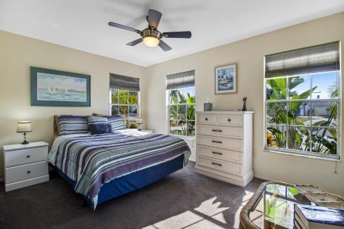a bedroom with a bed and a ceiling fan at Bella Villa in Bradenton