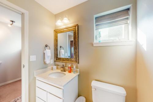 a bathroom with a sink and a mirror at At the Crossroads in Frisco