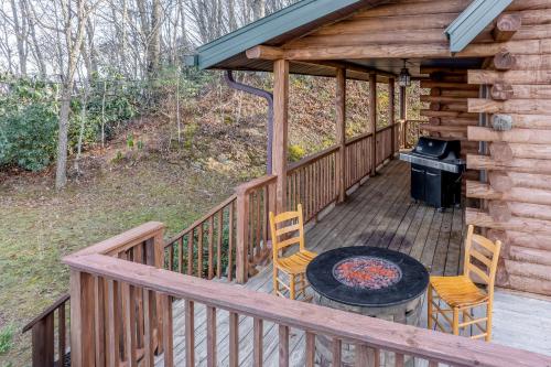 a deck with a table and chairs and a grill at Cloud Walk in Sylva