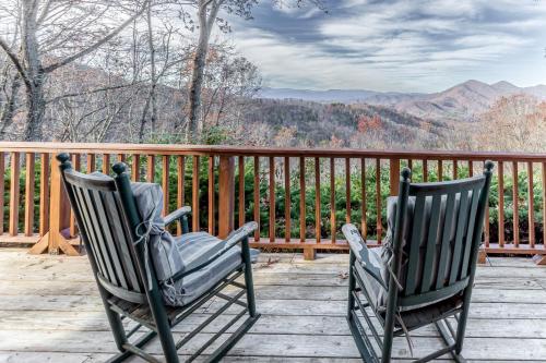 two rocking chairs sitting on a deck with a view at Cloud Walk in Sylva
