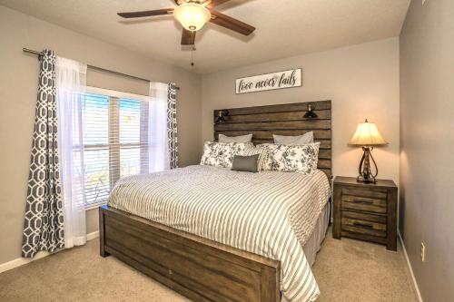 a bedroom with a bed and a ceiling fan at Cedar Lodge in Pigeon Forge