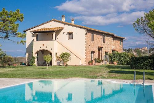 a house with a swimming pool in front of it at Podere Sant'Anna in Montaione