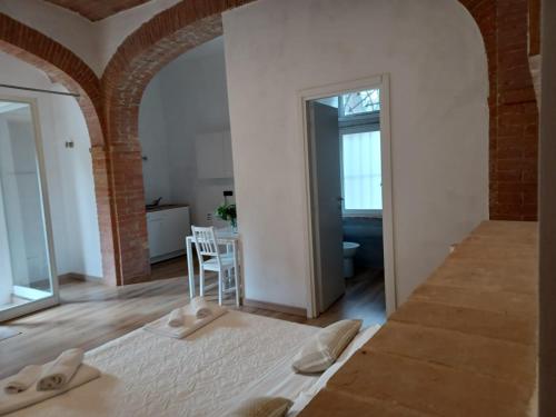 a bedroom with a bed and a table with a chair at L'Albero Di Gamelì in Chiusi