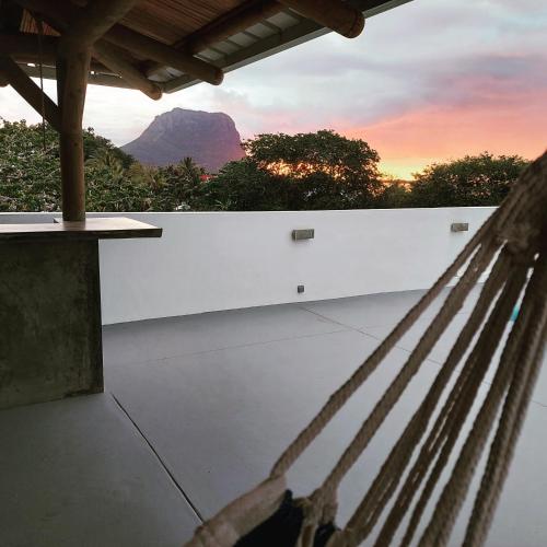 a hammock with a view of a mountain at Les Terrasses du Bénitier in La Gaulette