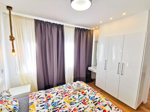 a bedroom with a bed with a colorful blanket at CityCenter Boutique Apartment in Larnaka