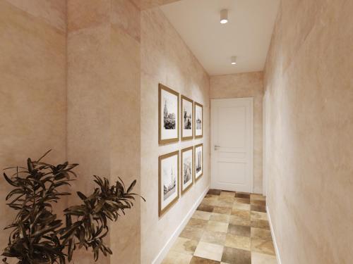 a hallway with pictures on the walls and a plant at Vila Perast Boutique Hotel in Perast