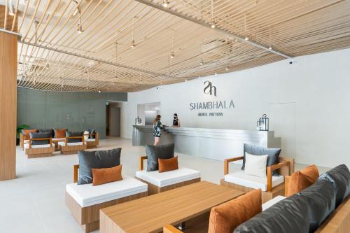 a lobby with couches and tables in a store at Shambhala Hotel Pattaya in Pattaya Central