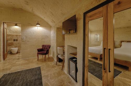 a hotel room with a bed and a bathroom at Solem Cave Suites in Urgup