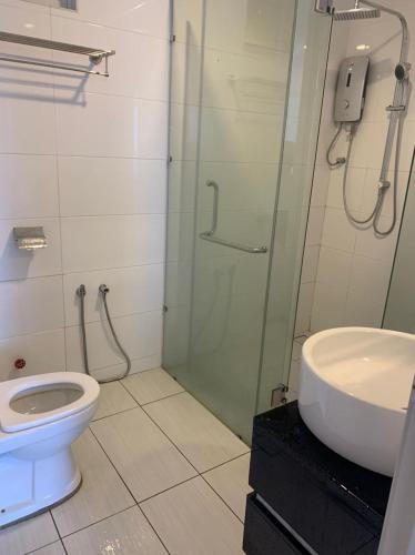 a bathroom with a shower and a toilet and a sink at ExcluSuites Malacca @ The Wave Residence in Melaka