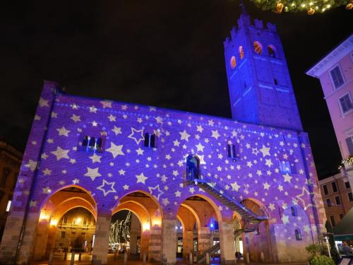 a building with a lit up facade with a clock tower at Locanda San Paolo in Monza