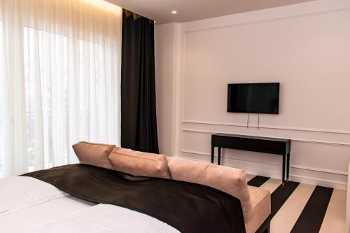 a bedroom with a bed and a flat screen tv at HOTEL BALKAN in Bijeljina