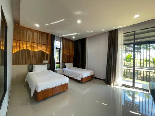 Postel nebo postele na pokoji v ubytování Phutara Resort and Spa
